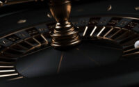 Modern Black And Golden Casino Roulette Wheel On Black Background. Close Up.